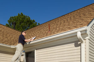 inspector examines a residential roof